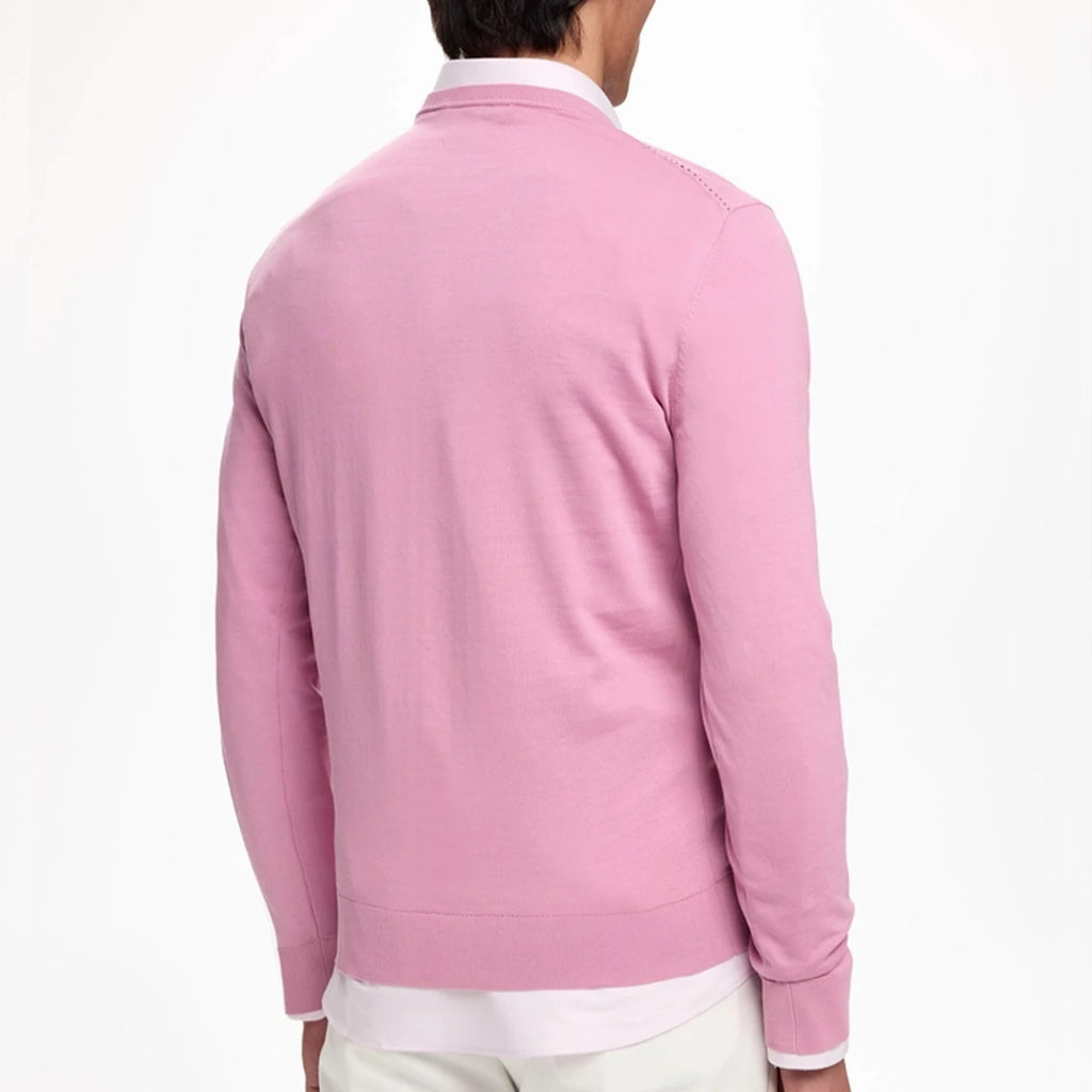 Back view of a man wearing a pink Men's Embroidered V-Neck Knit Sweater with a refined silhouette.